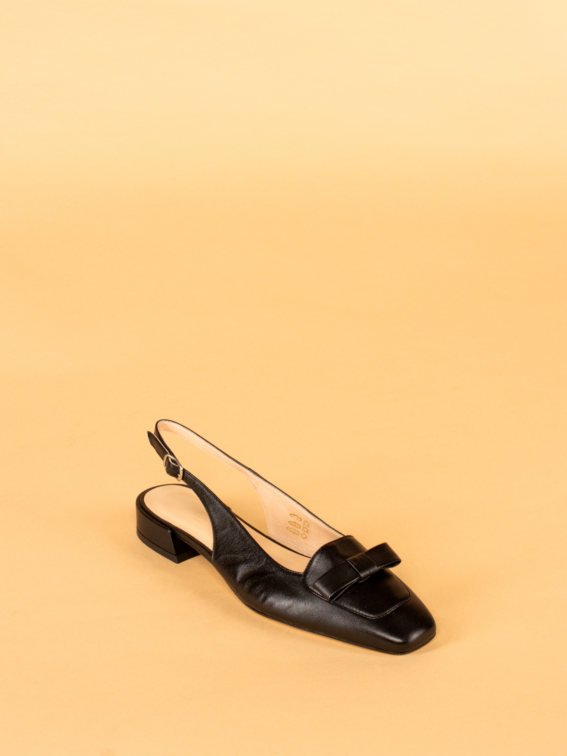 Shoe with bow and buckle detail