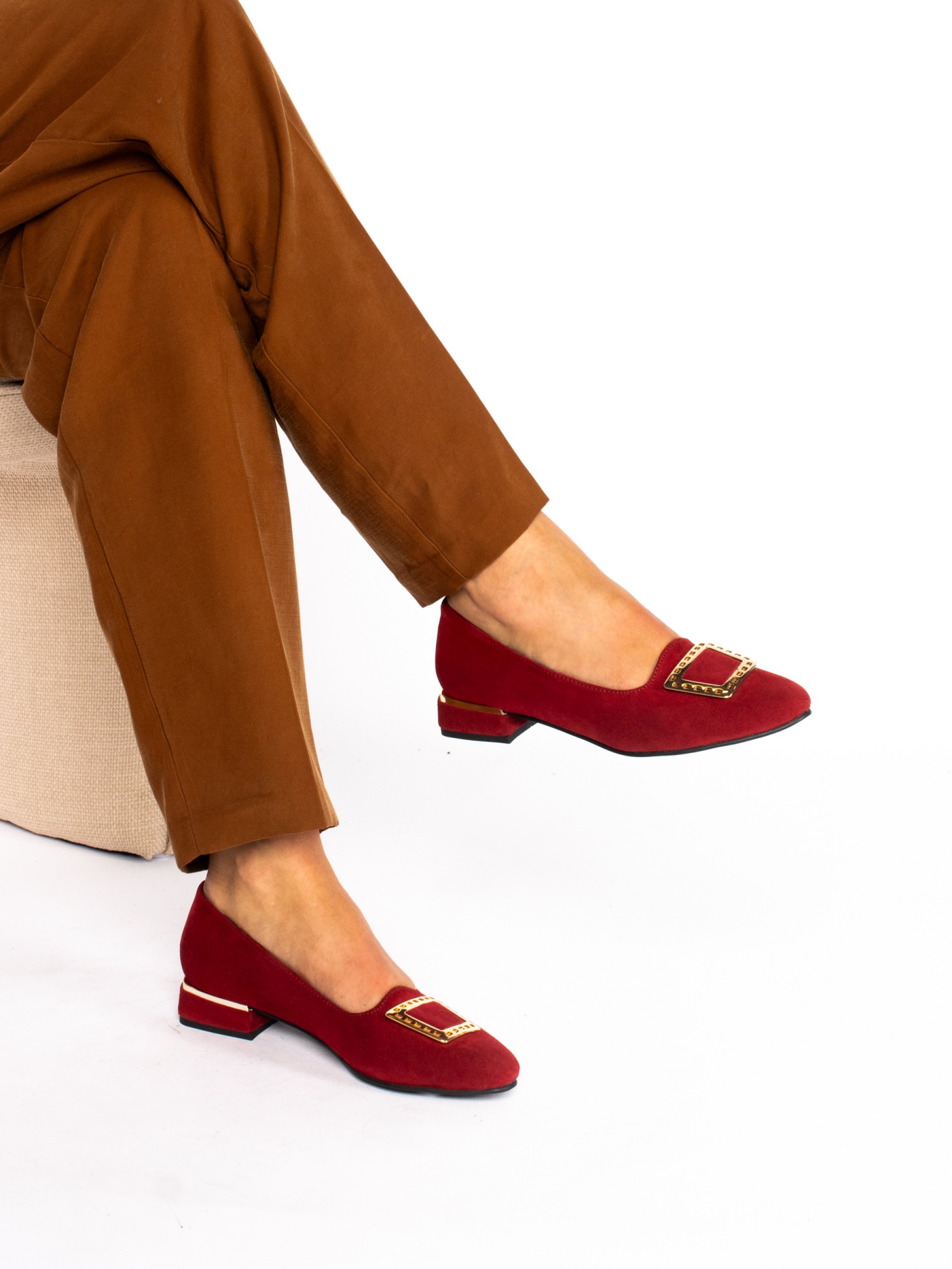 Low-heeled suede shoe with gold detail.