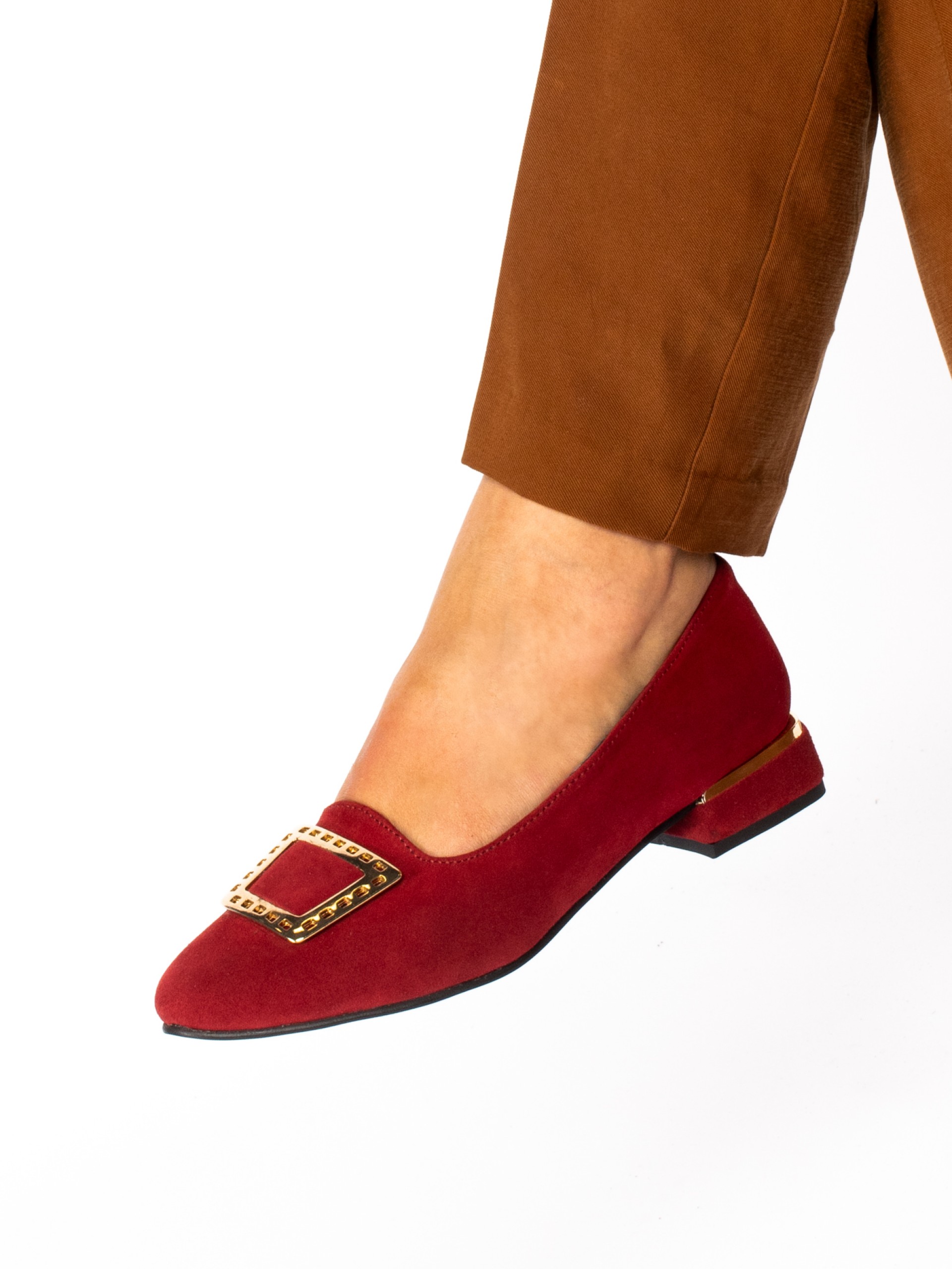 Low-heeled suede shoe with gold detail.