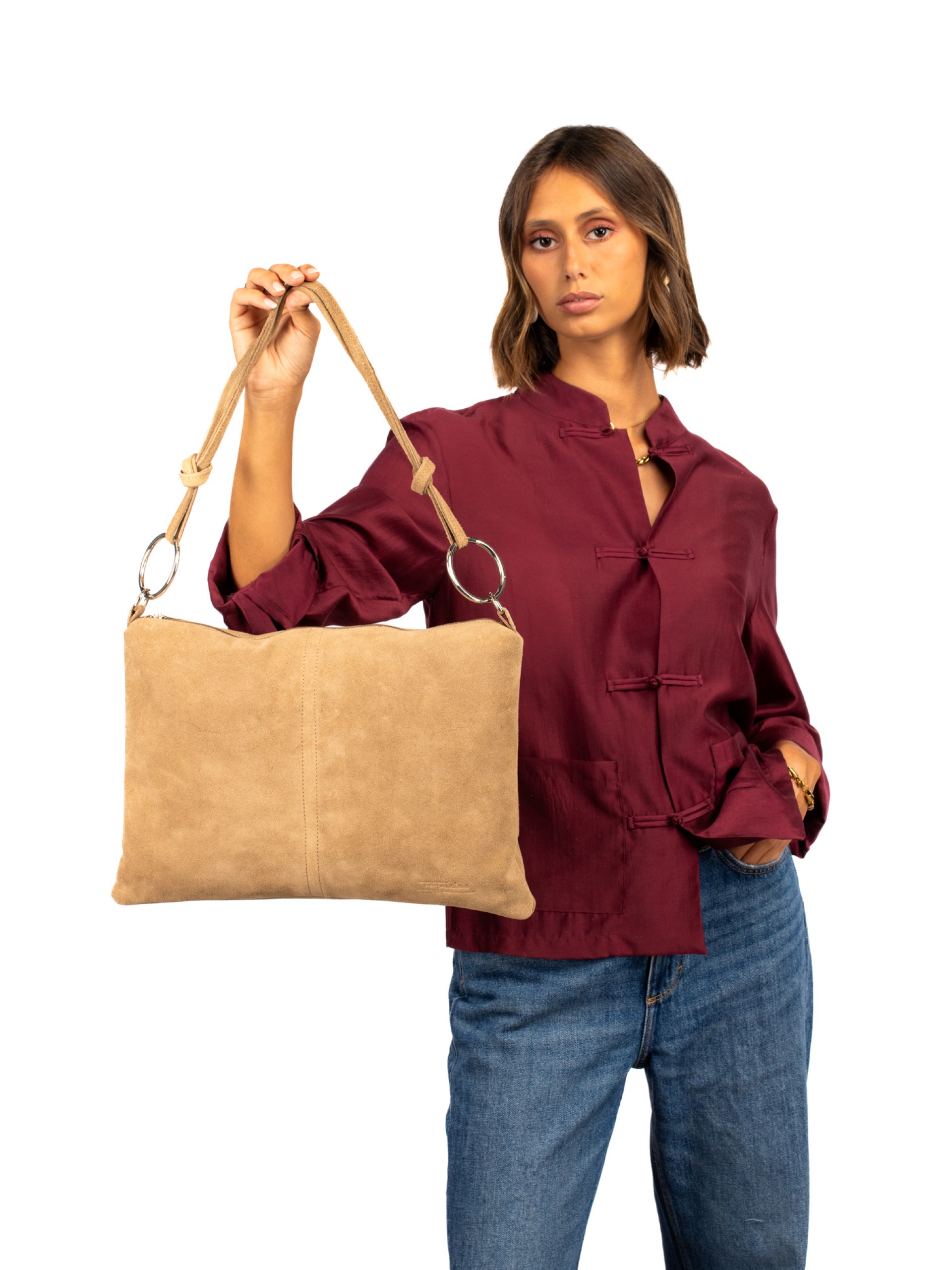 Suede shoulder bag with metal rings.