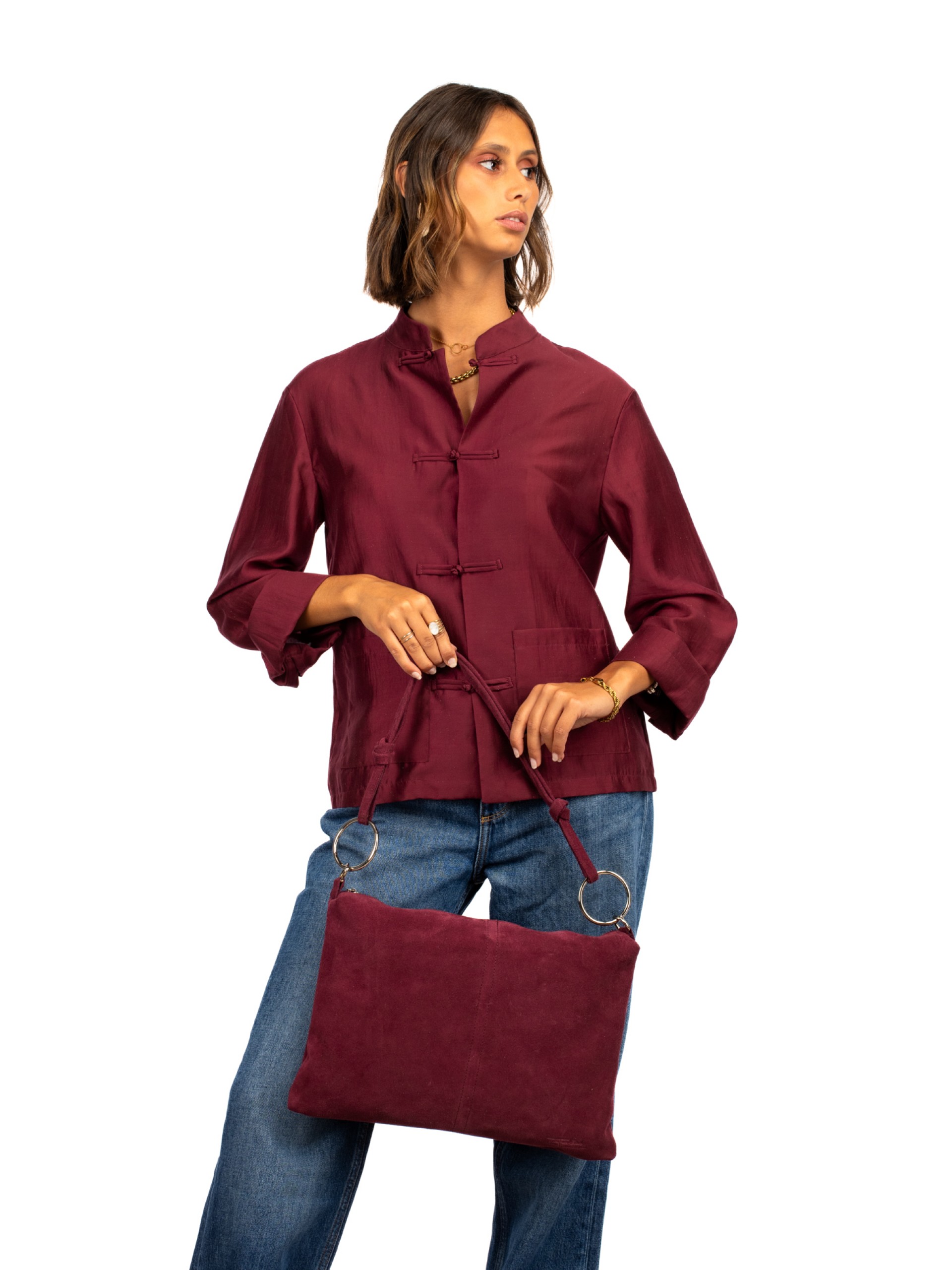 Suede shoulder bag with metal rings.
